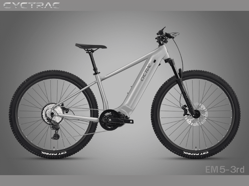 Cyctrac EM5-3rd hardtail electric mountain bike in metallic silver with integrated mid-drive motor, CST Patrol tires, and hydraulic disc brakes on gray background