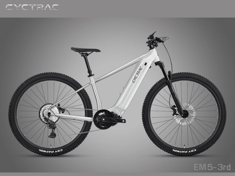Cyctrac EM5-3rd hardtail electric mountain bike in pearl white with integrated mid-drive motor, CST Patrol tires, and hydraulic disc brakes on gray background